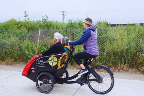 Cycling Without Age trishaw transporting elderly passengers on a bike path in Santa Barbara