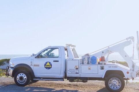 Freeway Service Patrol tow truck against ocean background