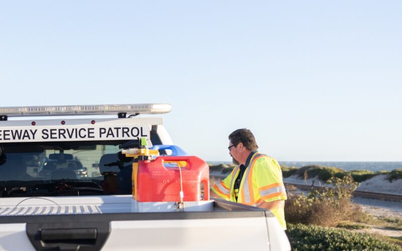 Freeway Service Patrol agent getting gas for a stranded vehicle