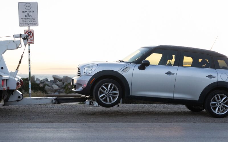 Mini cooper getting towed by the freeway service patrol in Santa Barbara